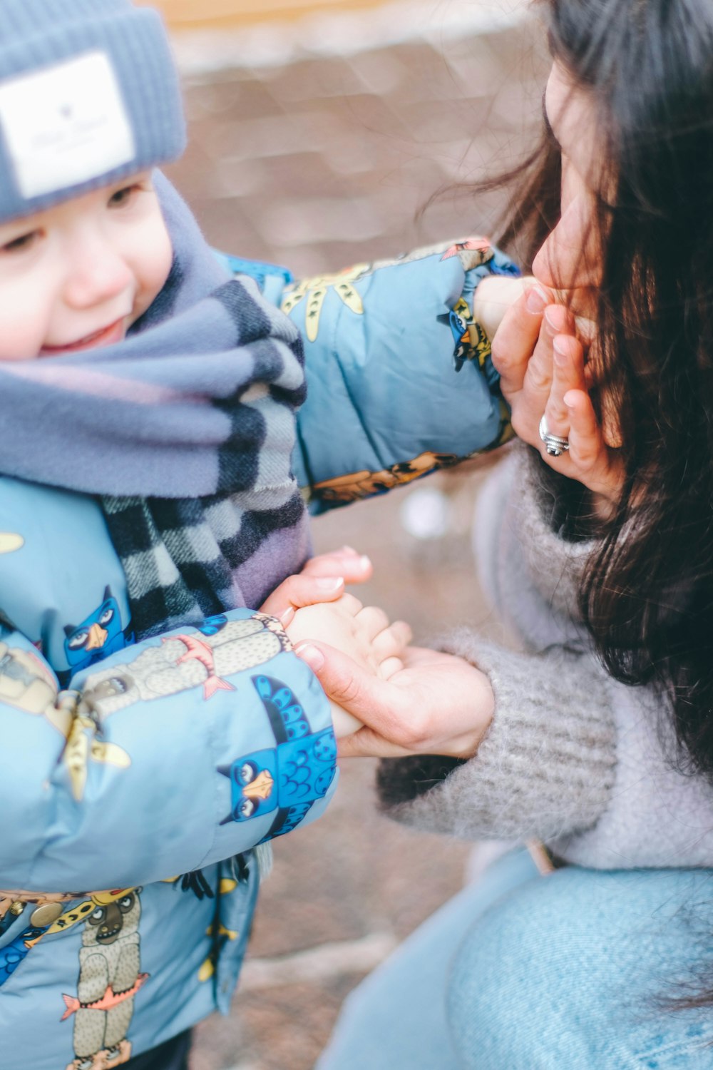 a woman holding a small child's hand