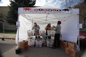 A hoso marketing representative handing out product samples at a crowded college campus.