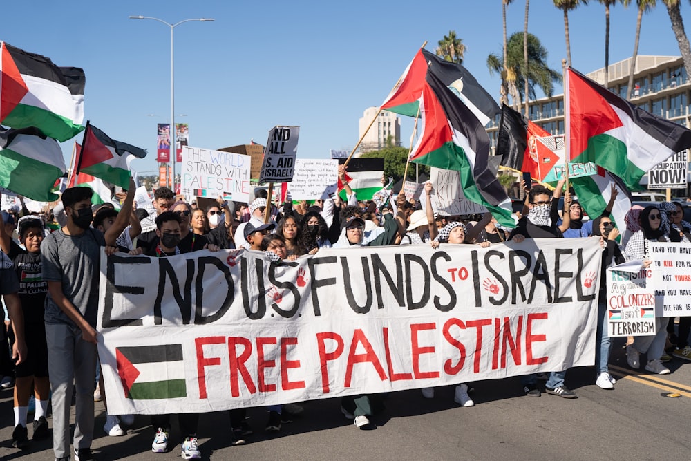 a large group of people holding flags and banners