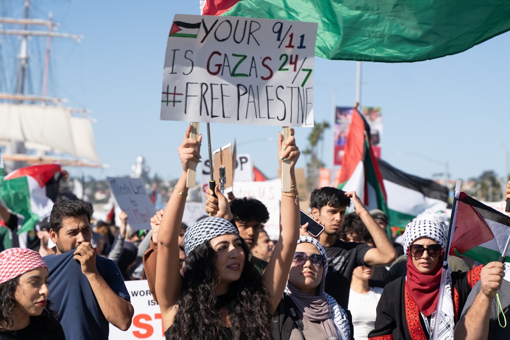 a group of people holding up signs and flags