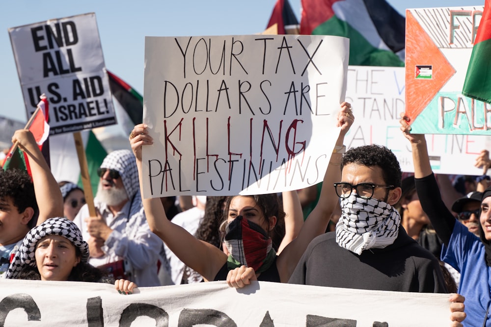 a group of people holding signs and flags