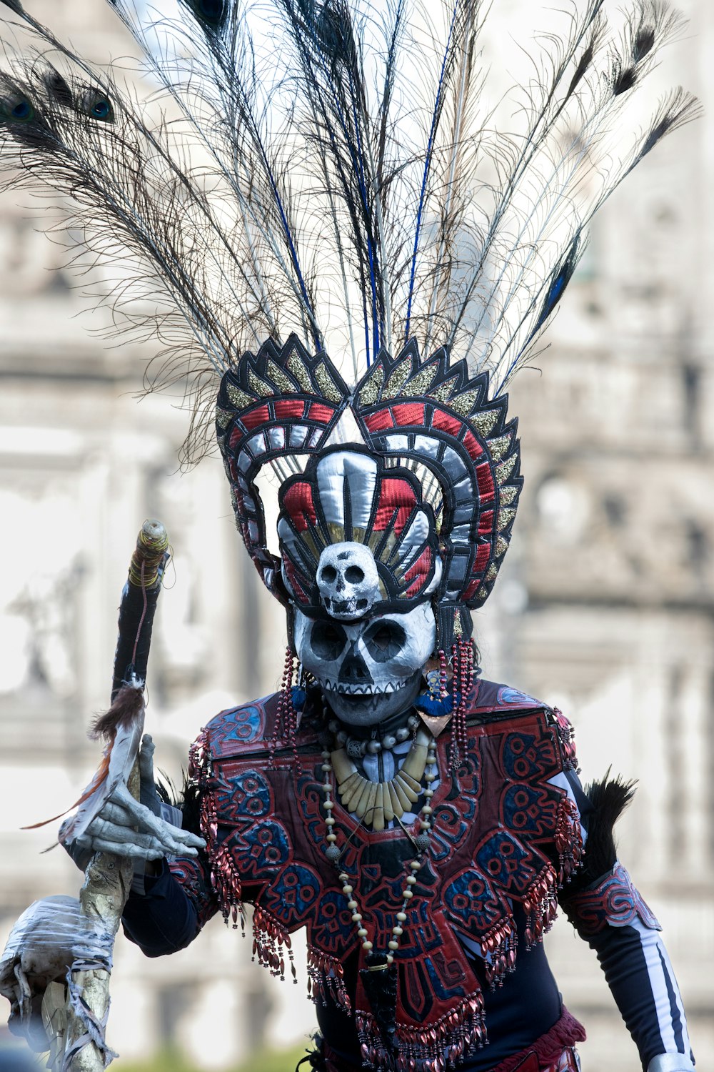 a man in a costume with feathers on his head