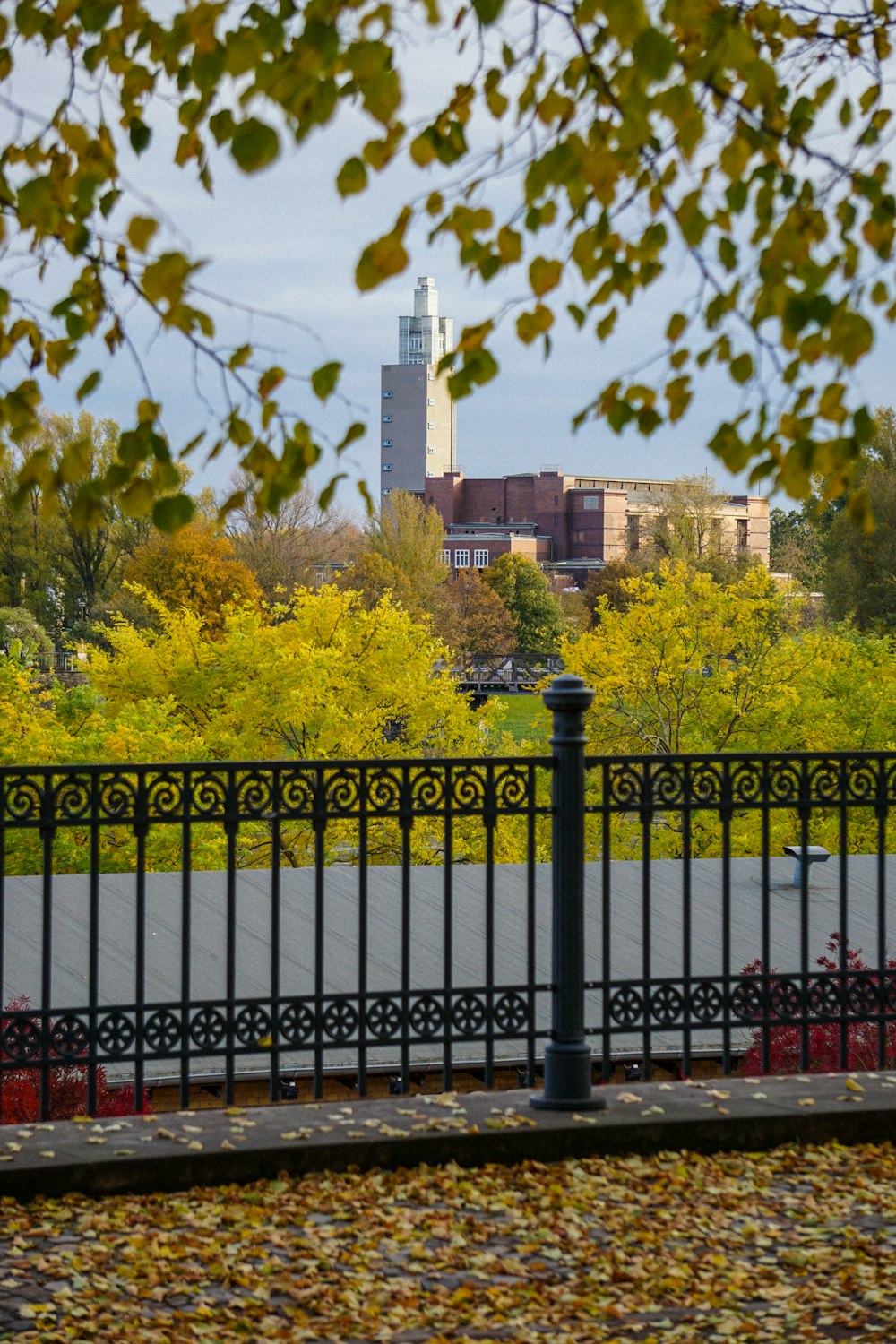 a black fence with a clock tower in the background