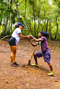 Volunteers planting trees together in a sunny community park.