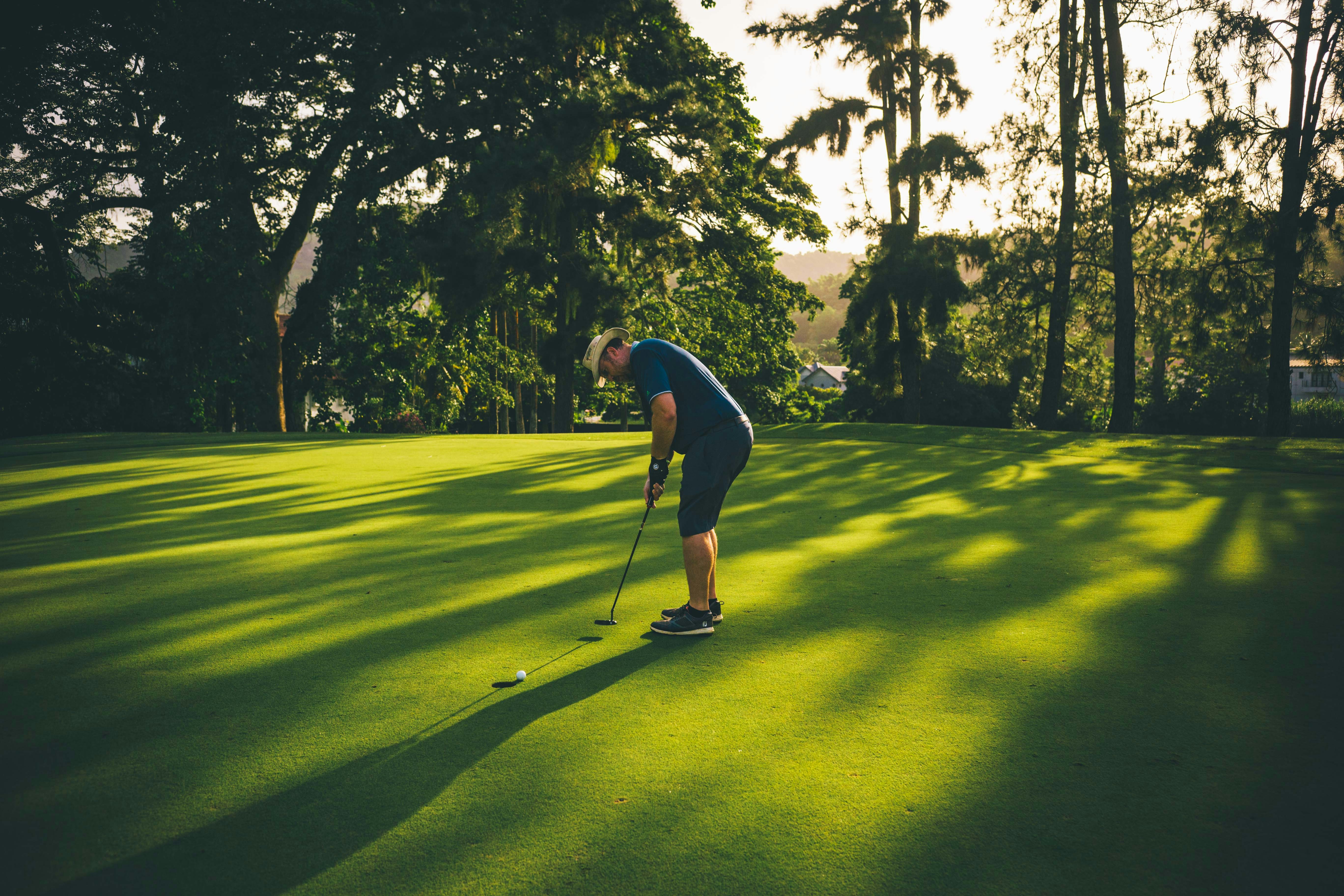 a man playing golf on a sunny day