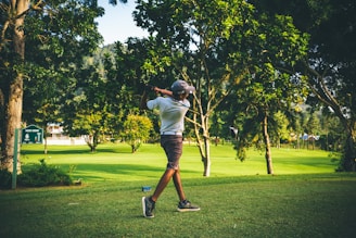 Golfers celebrating a successful shot on a lush green course.