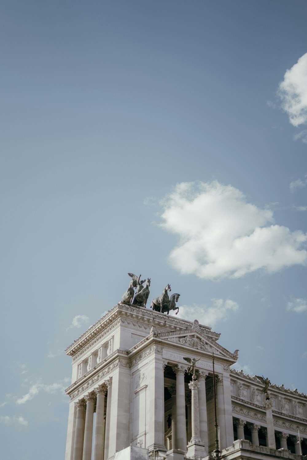 a tall building with statues on top of it