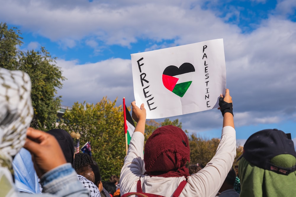 a group of people holding up signs in the air