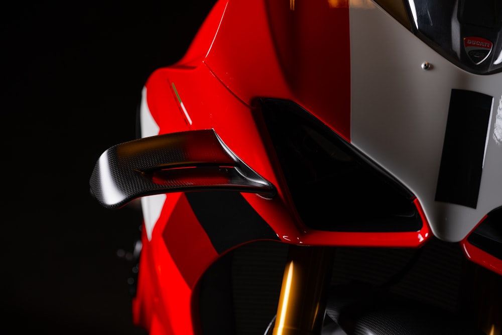 a close up of a red and white motorcycle