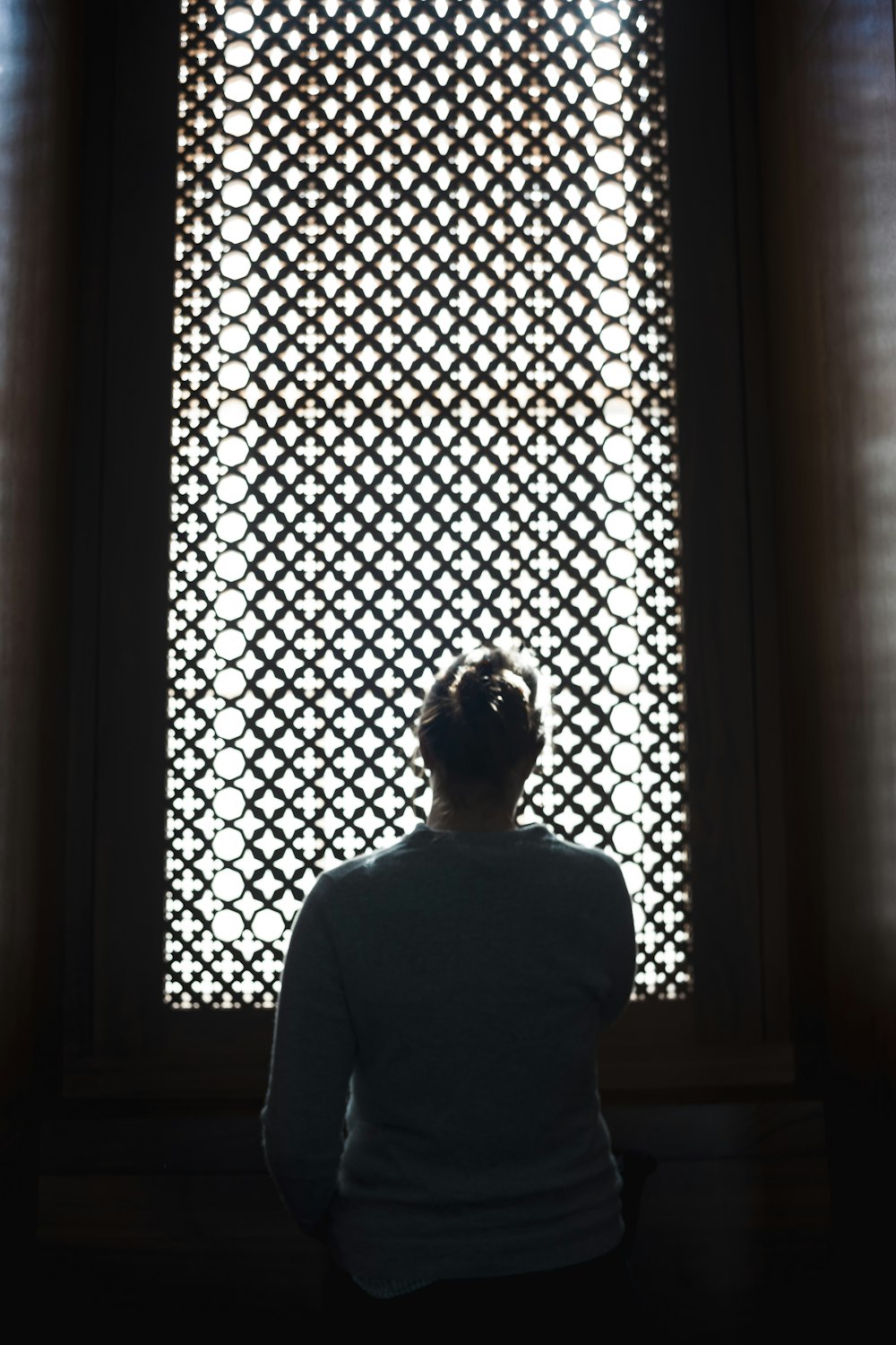 a person sitting in front of a window