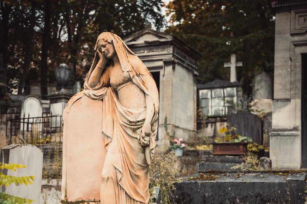 a statue of a woman in a cemetery