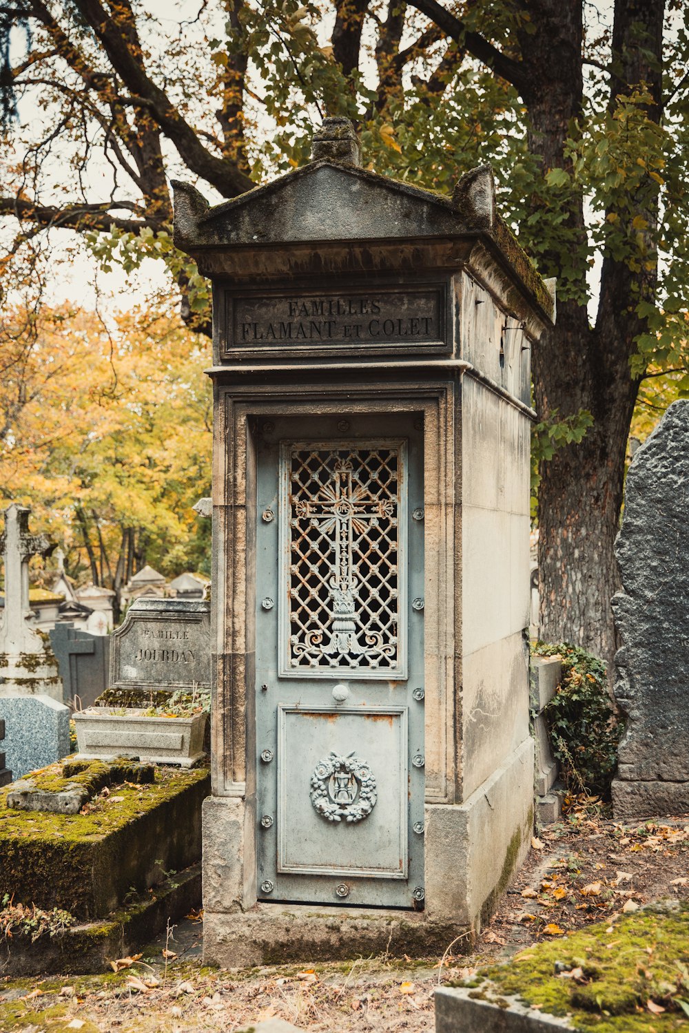 an old cemetery with a small blue door