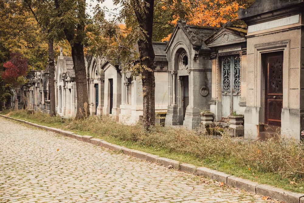 a row of old tombstones on a cobblestone street