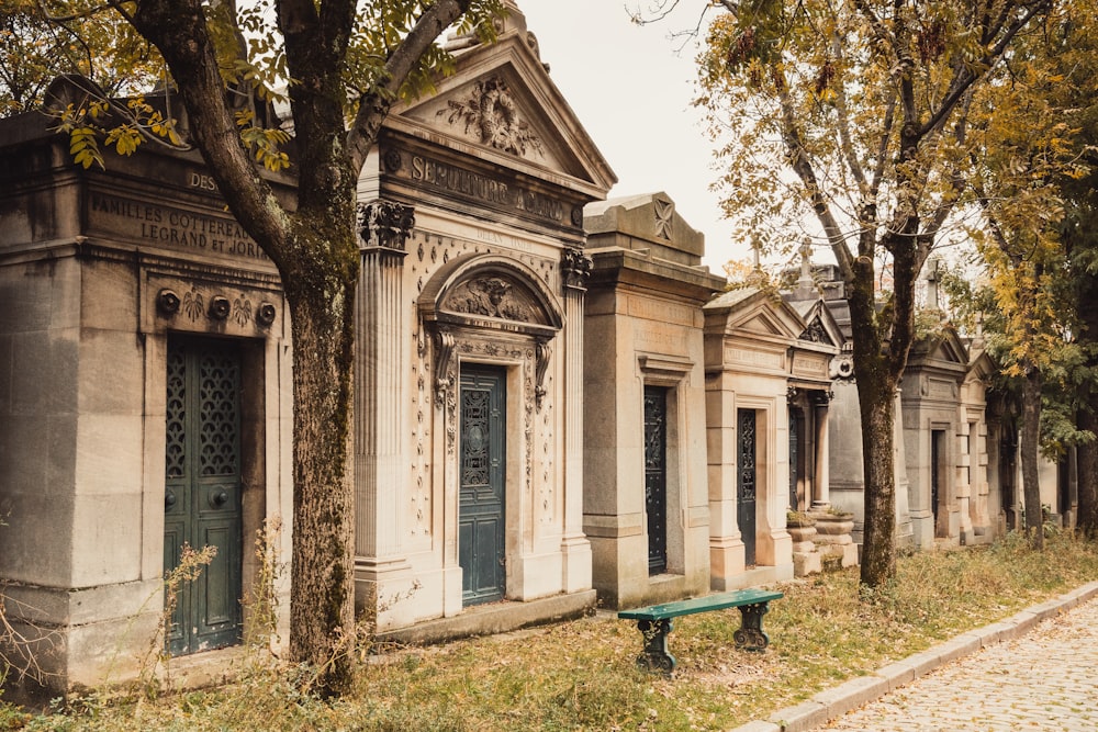 an old cemetery with a green bench in front of it