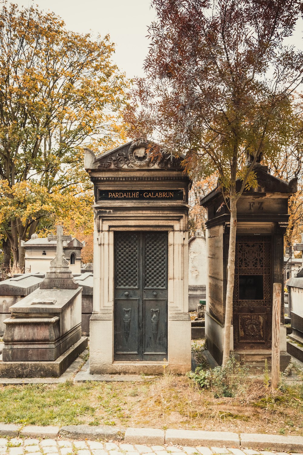 a cemetery with tombstones and trees in the background