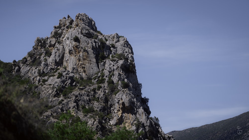 a large mountain with a very tall rock face