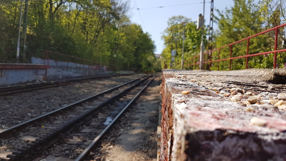 a rail road track with trees in the background