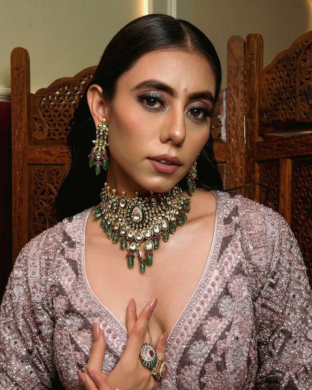 a woman wearing a necklace and earrings