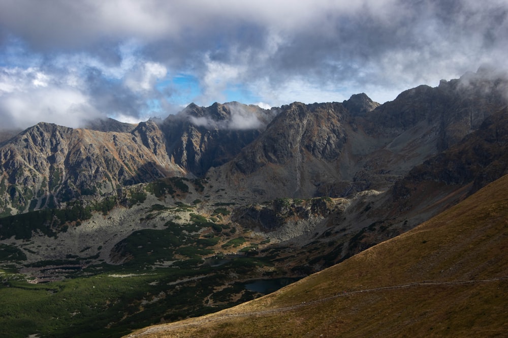 a view of a mountain range with clouds in the sky