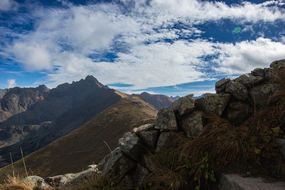 a rocky outcropping with a mountain in the background