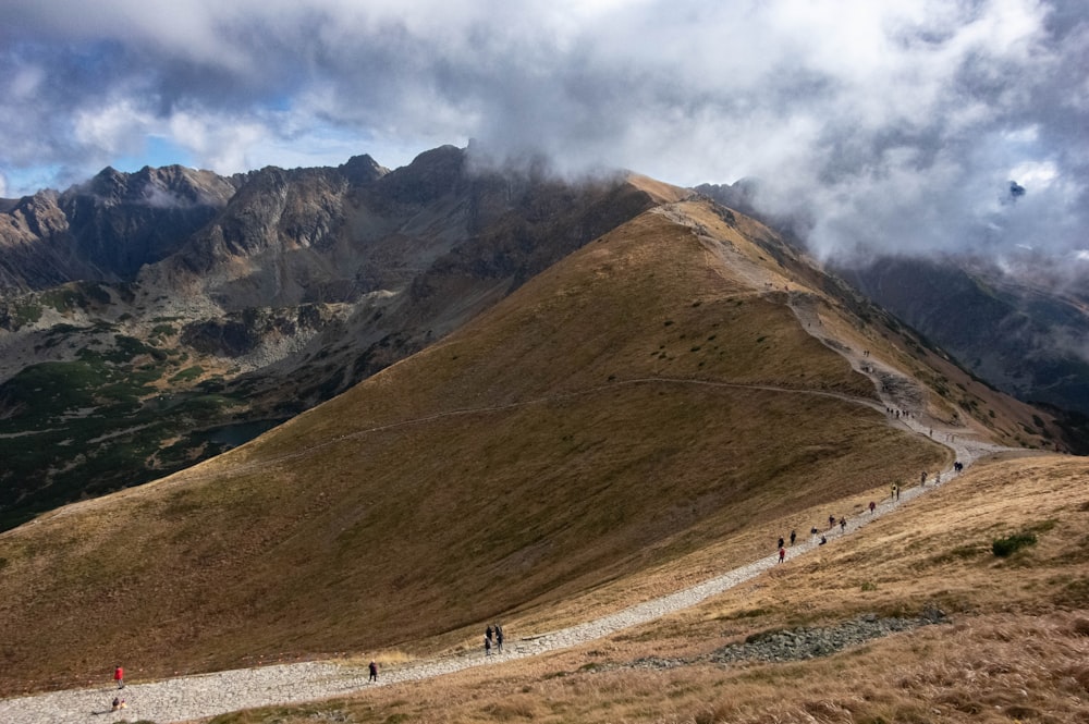 a group of people walking up the side of a mountain
