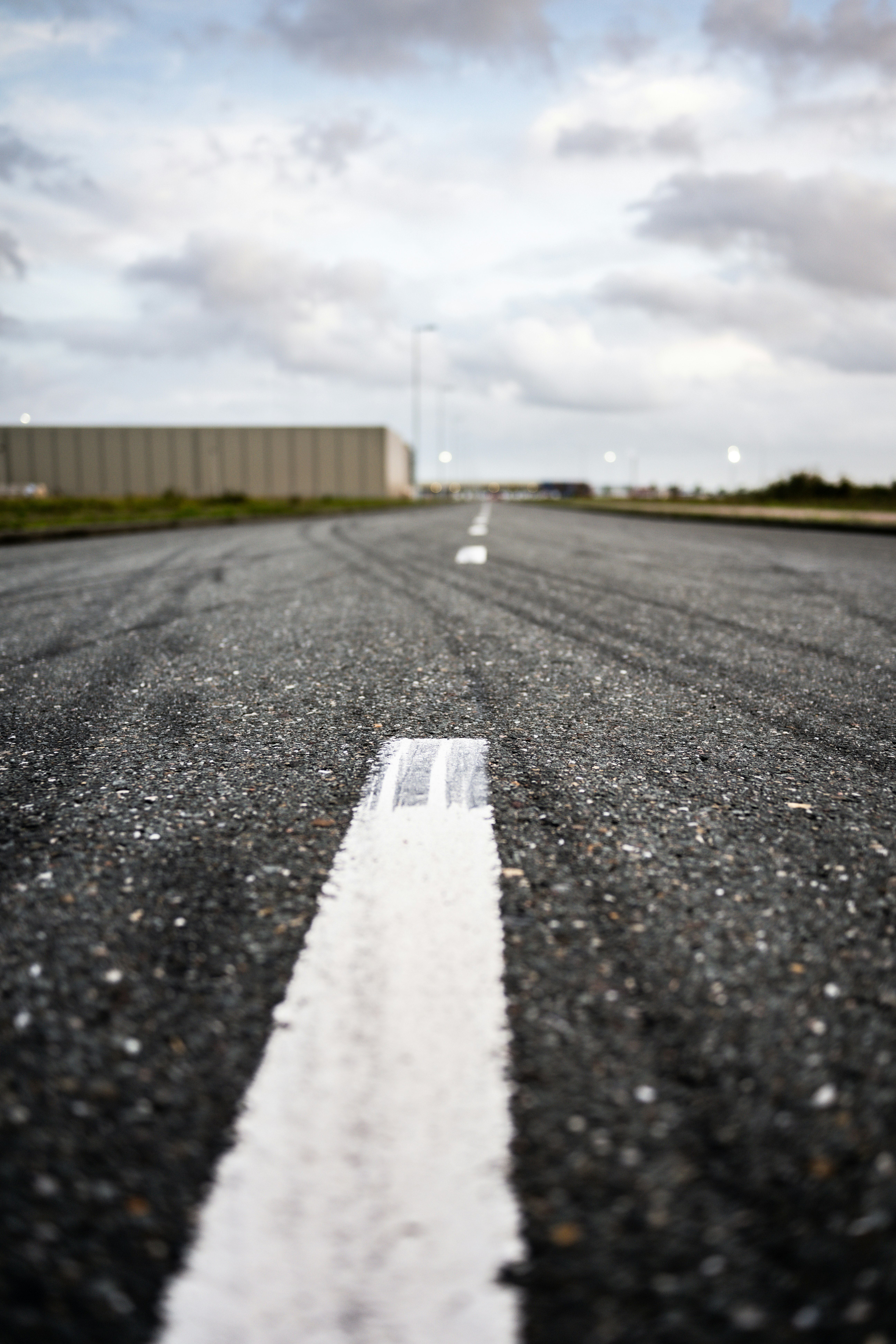 A white line on the middle of an empty road photo – Free Dark Image on ...
