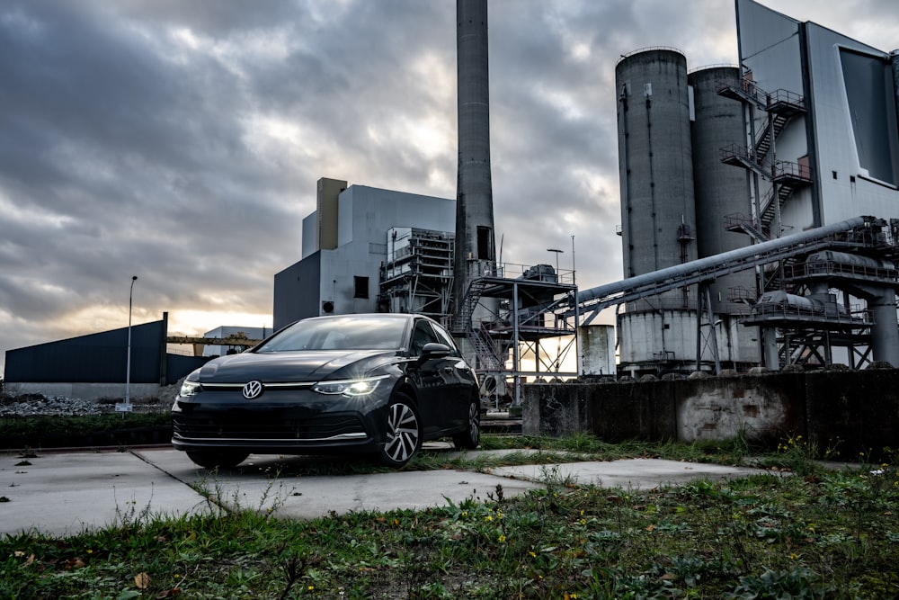 a car parked in front of a factory