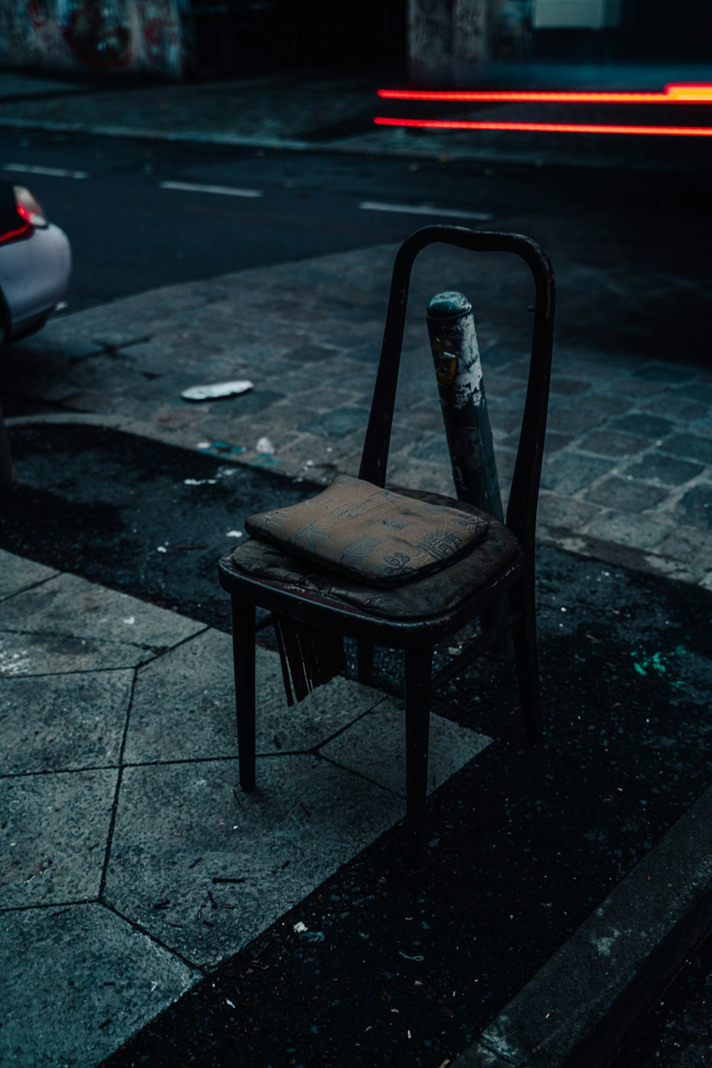 a chair sitting on the side of the road