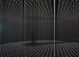 Installation art featuring light and shadow interplay in a gallery.
