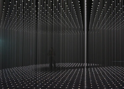 An installation piece featuring hanging lights casting artistic shadows.