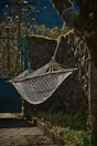 A hammock hanging between two trees in a quiet garden.