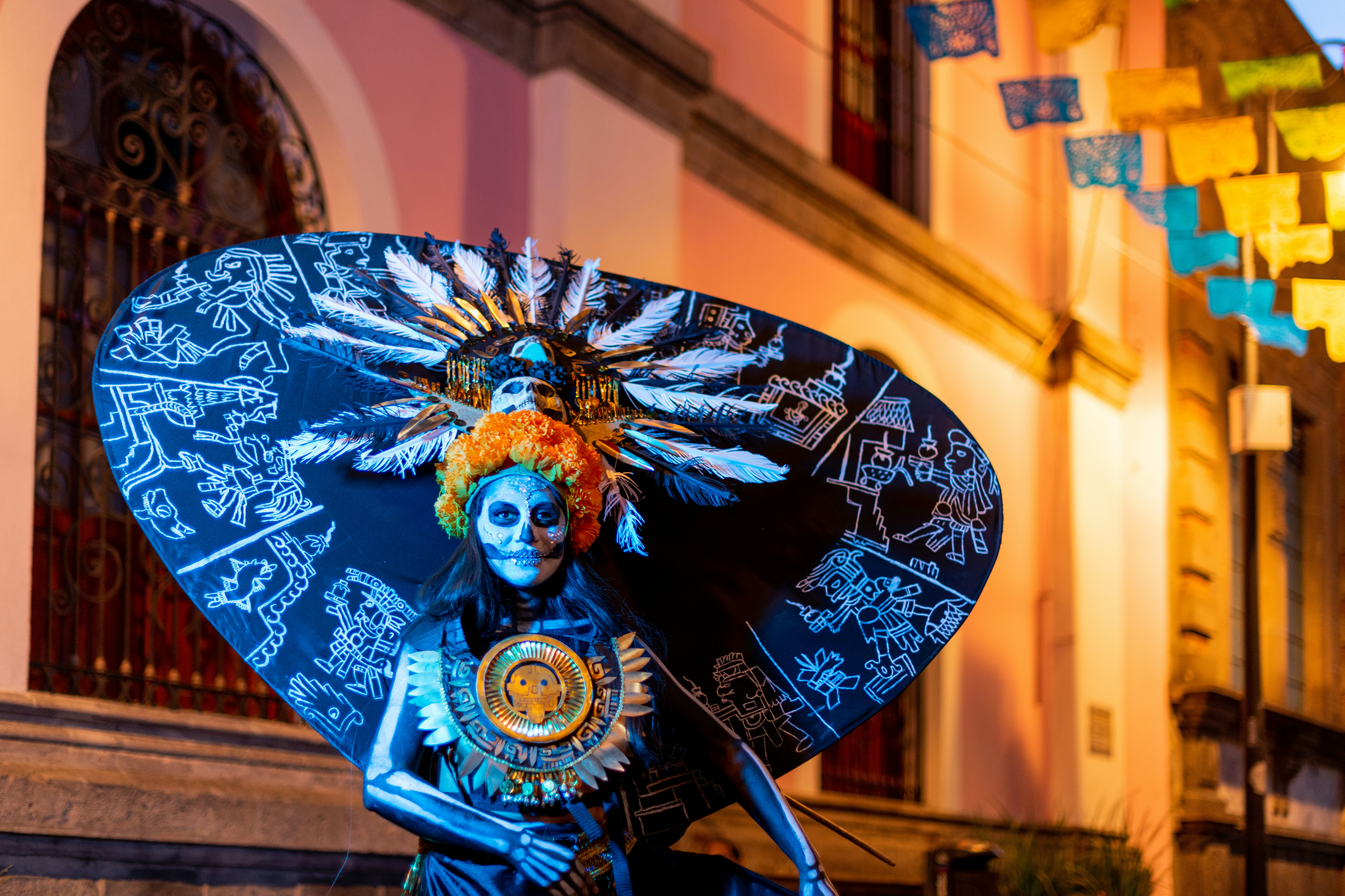 a woman dressed in a costume and holding an umbrella, Catrina