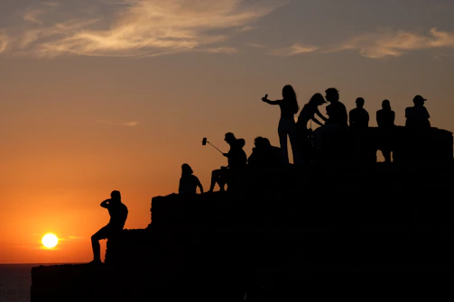 A dynamic group photo of photographers capturing a sunset in Hyderabad.