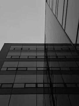 A sleek modern building under construction against a gray sky.