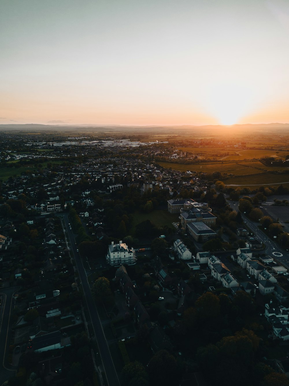 an aerial view of a city at sunset