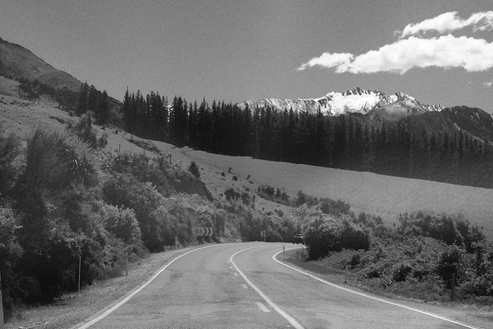 a black and white photo of a mountain road