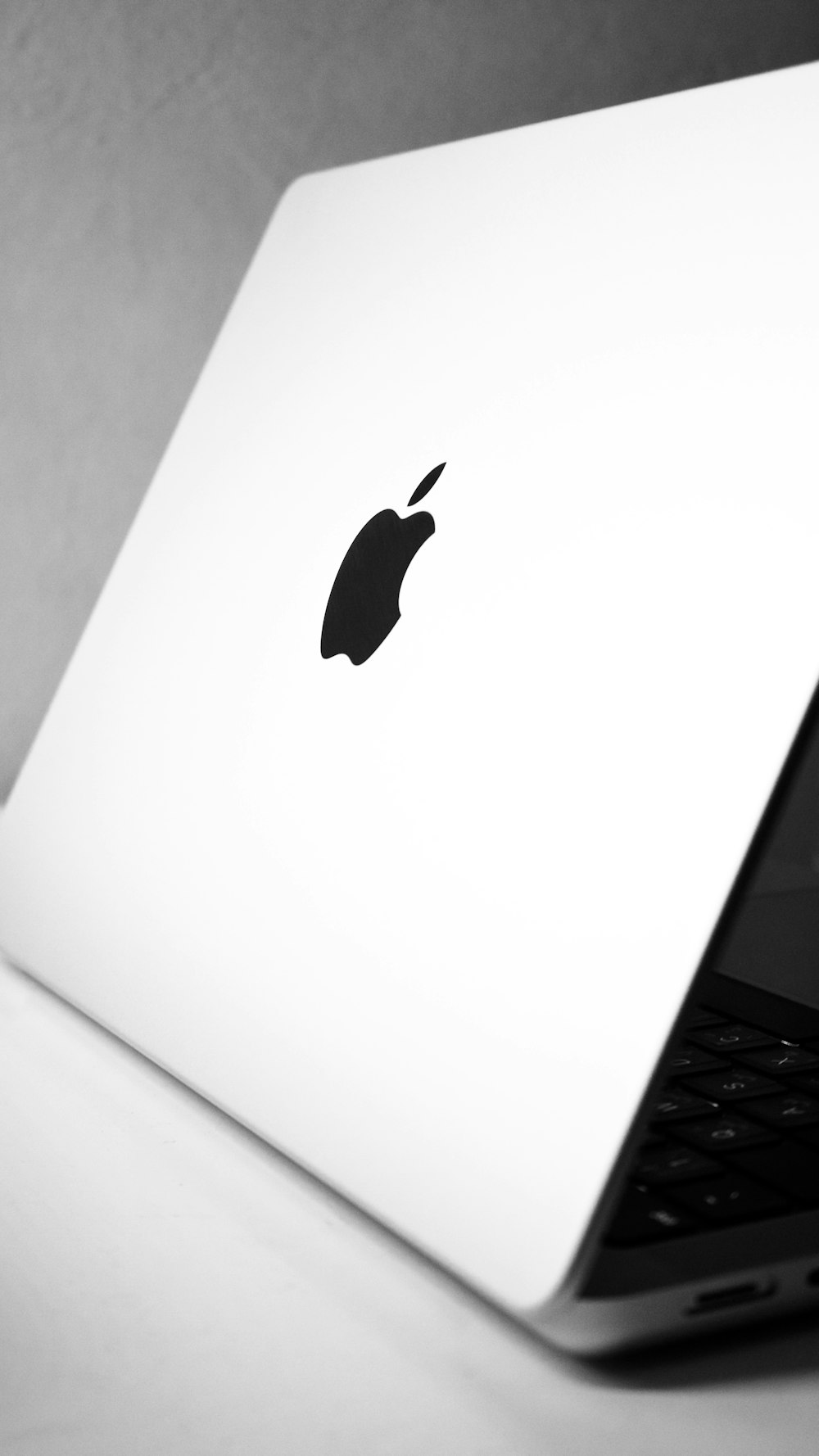 a black and white photo of an apple laptop