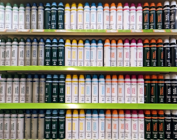 A neatly arranged display of personal care products including shampoos and lotions with blue and white packaging.