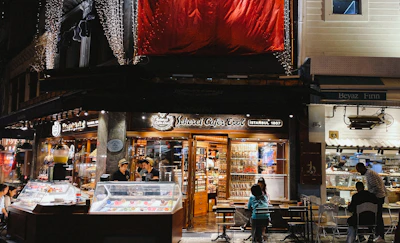 Evening scene of the café’s exterior with soft glowing lights and welcoming atmosphere.