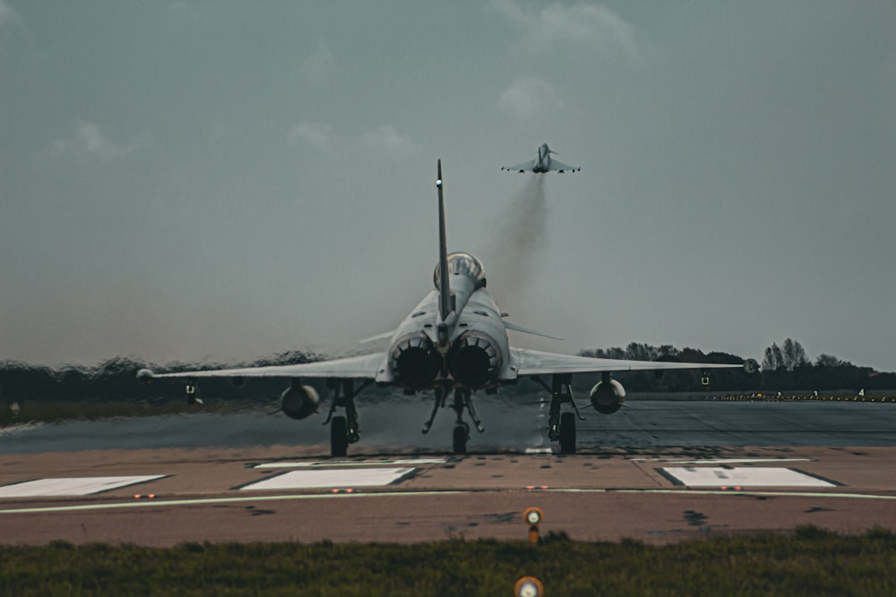 a fighter jet taking off from an airport runway