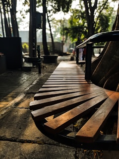 Outdoor seat cushions placed on a wooden bench under dappled sunlight