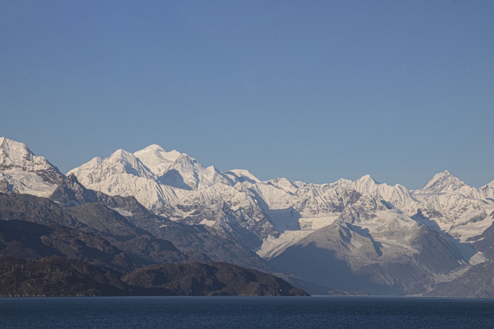 a mountain range with a body of water in the foreground