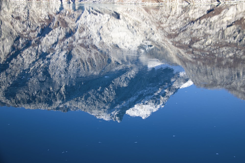 the reflection of a mountain in the water