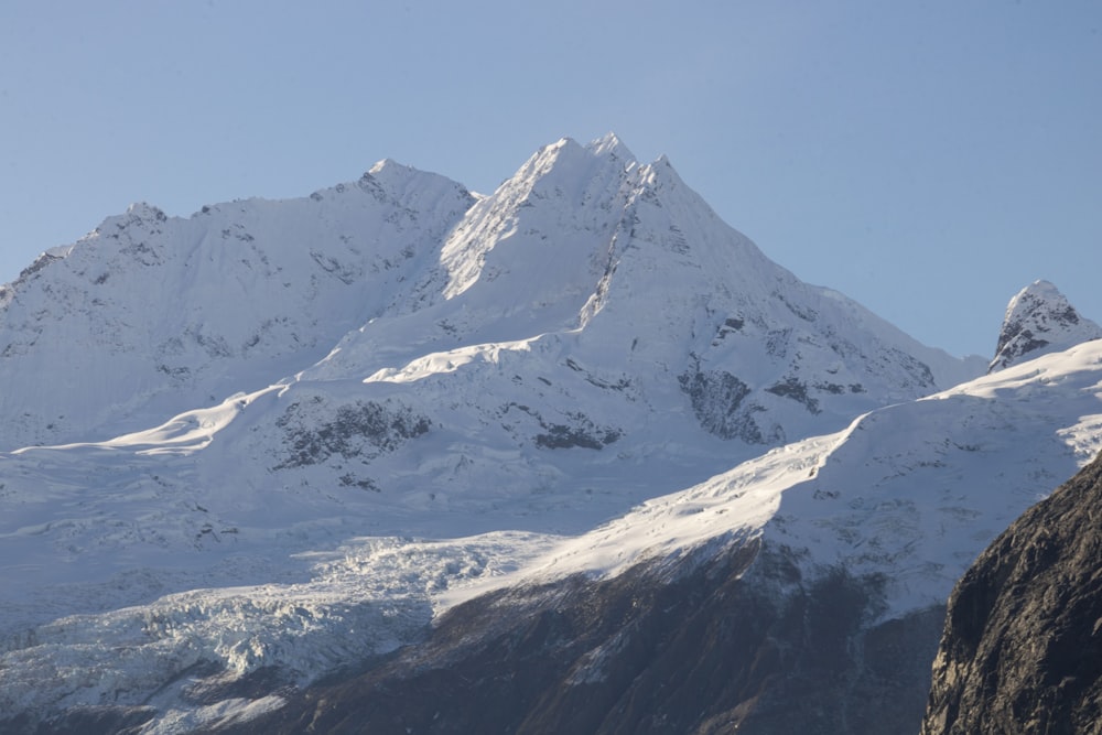 a snow covered mountain is seen from a distance
