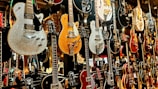 Artistic shot of Hunter’s vintage guitar collection displayed against a graffiti wall.