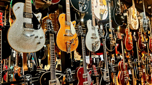 A vibrant collection of pickguards hanging on a wall, showcasing the diversity of the Vivacapa brand