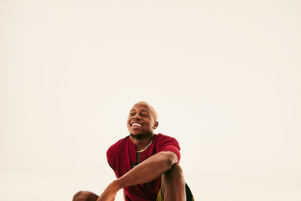 a man sitting on the ground with a frisbee in his hand