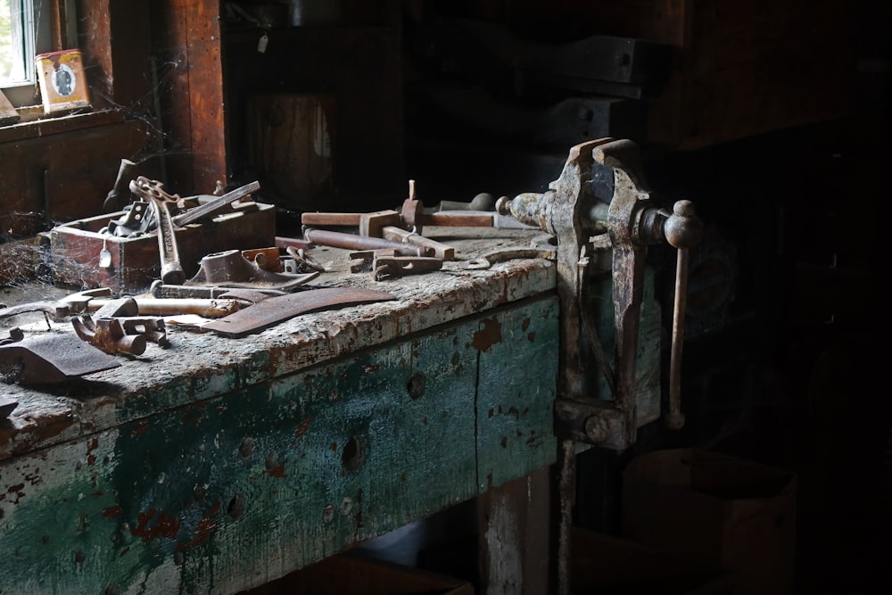 a wooden table topped with lots of tools