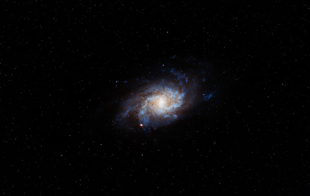 a spiral galaxy in the middle of the night sky