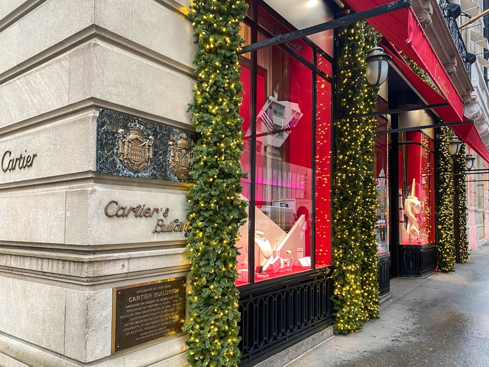 a store front with christmas decorations on the windows